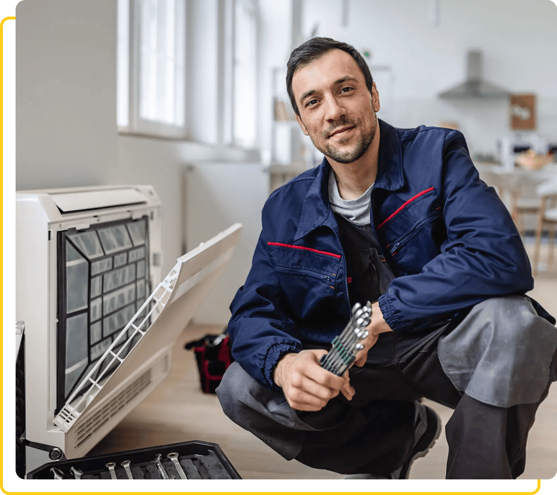 Repairman fixing air conditioning unit indoors.