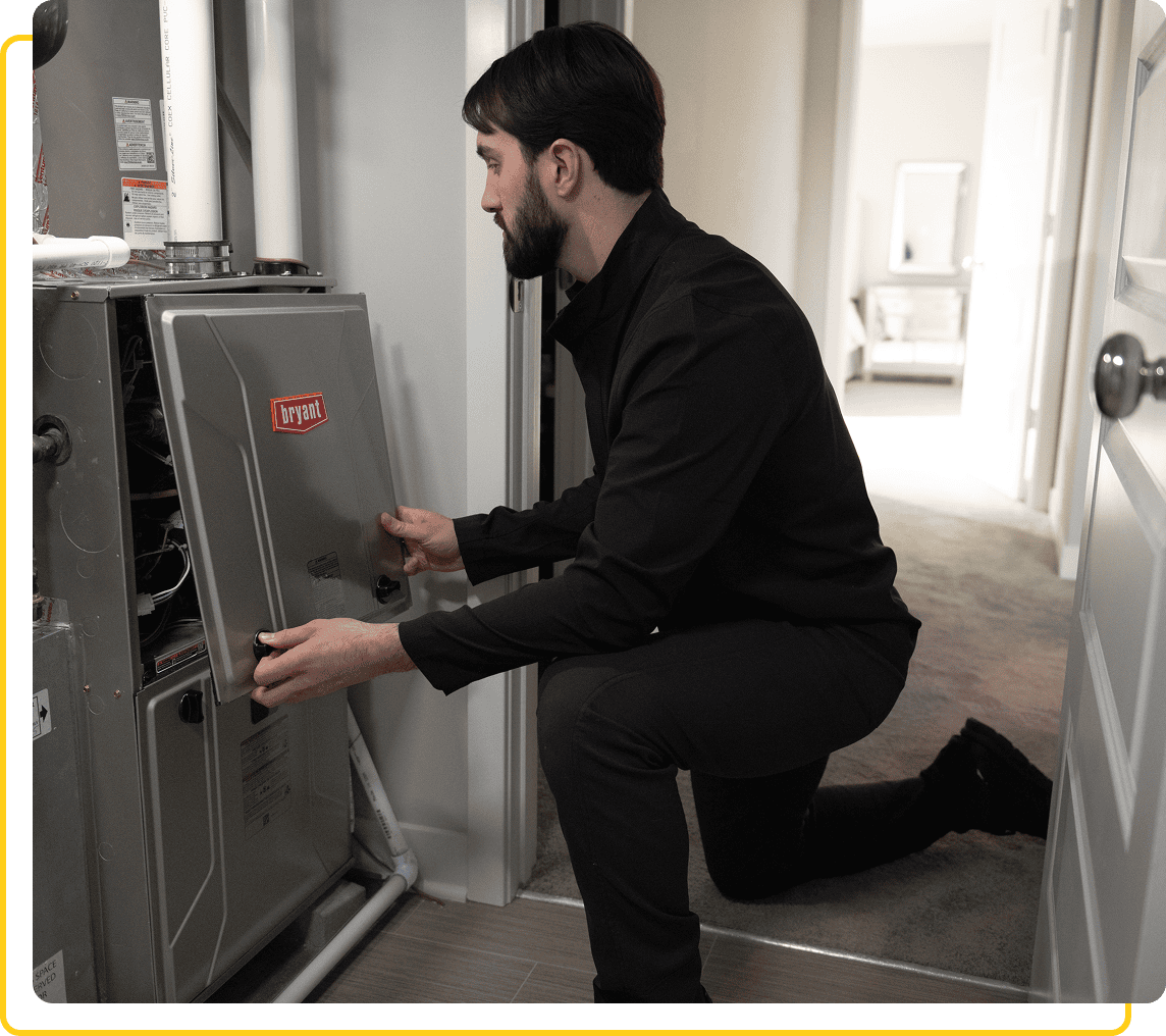 Technician servicing a home heating system.