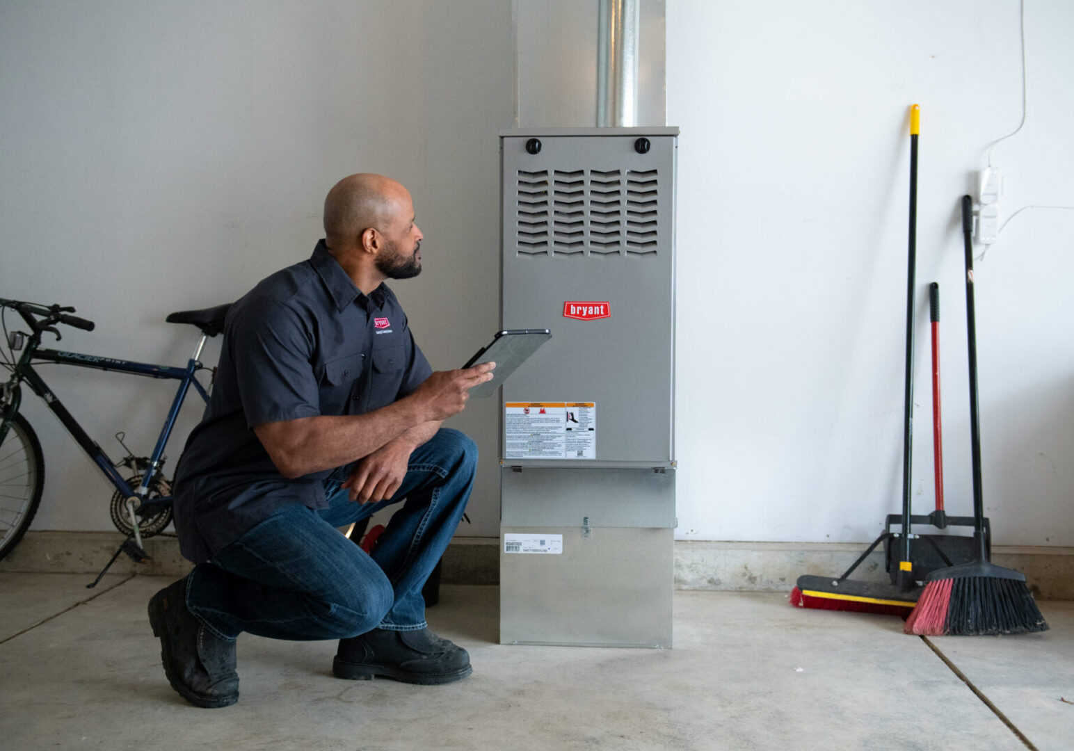 Technician inspecting a home heating system.