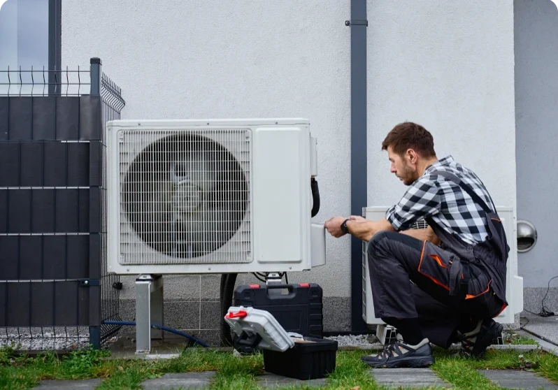 Man working on HVAC system maintenance